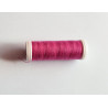 Sewing machine thread - dark rose pink color - 200m spool, placed on a white background