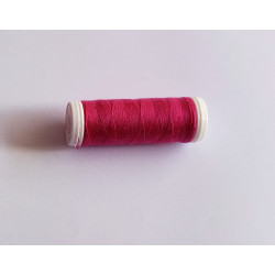 Sewing machine thread - fuchsia color - 200m spool, placed on a white background