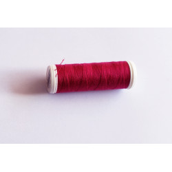 Sewing machine thread - raspberry color - 200m spool, placed on a white background