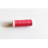 Sewing machine thread - intense pink color - 200m spool, placed on a white background