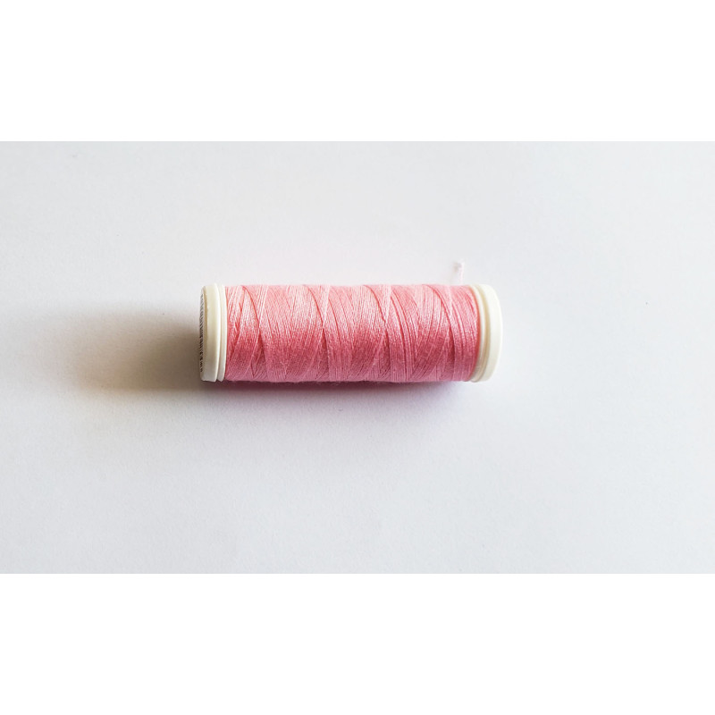 Sewing machine thread - light pink color - 200m spool, placed on a white background