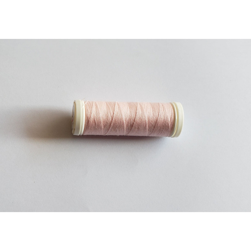 Sewing machine thread - pale pink color - 200m spool, placed on a white background