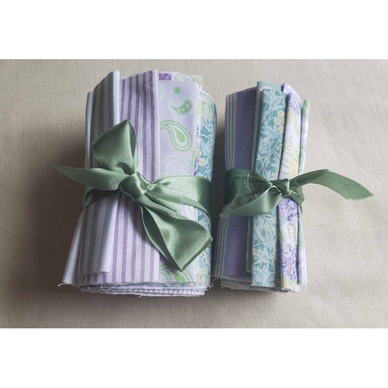 Jelly roll pre cuts bundle - sage/lilac mood two bundle sizes, placed on a cream background