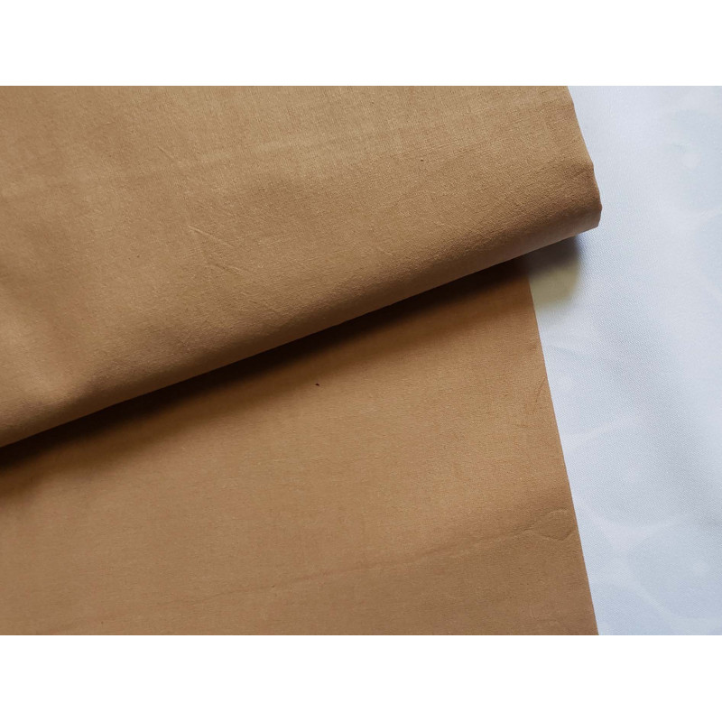 medium-weight cotton fabric -  caramel color, the fabric with the fold, placed across the frame