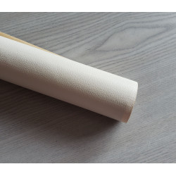 Self-Adhesive Faux leather fabric - cream, the roll of the fabric placed across the grey table