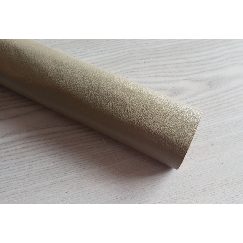 Self-Adhesive Faux leather fabric - taupe, the roll of the fabric placed across the grey table