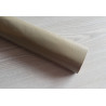 Self-Adhesive Faux leather fabric - taupe, the roll of the fabric placed across the grey table