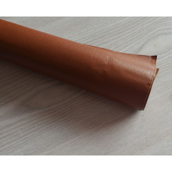 Self-Adhesive Faux leather fabric - chestnut, the roll of the fabric placed across the grey table