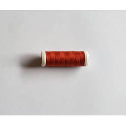 Sewing machine thread -  rust color - 200m spool, placed on a white background