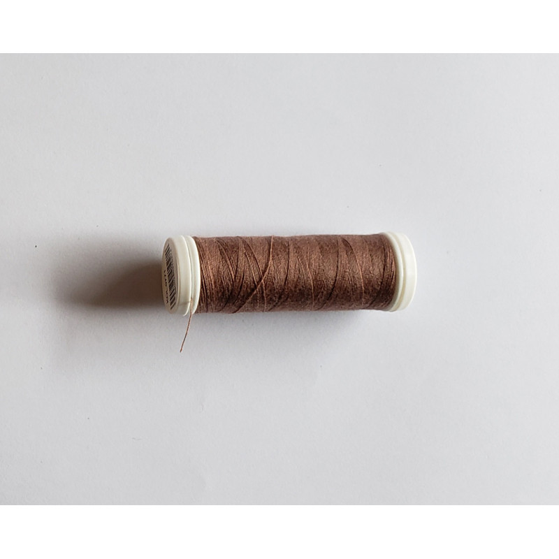 Sewing machine thread -  light brown color - 200m spool, placed on a white background