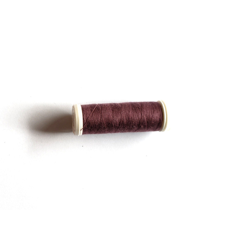 Sewing machine thread -  brown color - 200m spool, placed on a white background