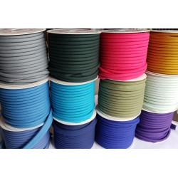 Plain flanged piping cord, range of colors on reels, placed one reel on another