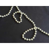 round pearl trim - ivory  twisted on a black background