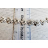 Rhinestones trim- daisies, placed on a grey background with the ruler