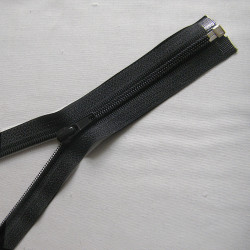 Open-ended plastic coil zip - black - 25cm long on a grey background