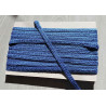 Upholstery trim 15mm - blue color, full reel placed on a grey table