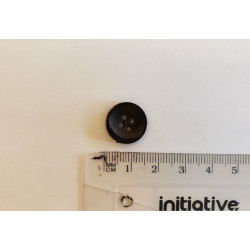 Small, black suit button with the ruler on a white background