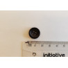 Small, black suit button with the ruler on a white background