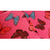 Colorful butterflies on hot pink- fleece, the fabric with the fold to show both sides of the fabric