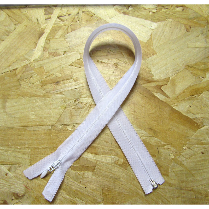 Invisible Zip 45 cm - white - open end zip on a wooden background Invisible Zip 45 cm - white - open end zip on a wooden background