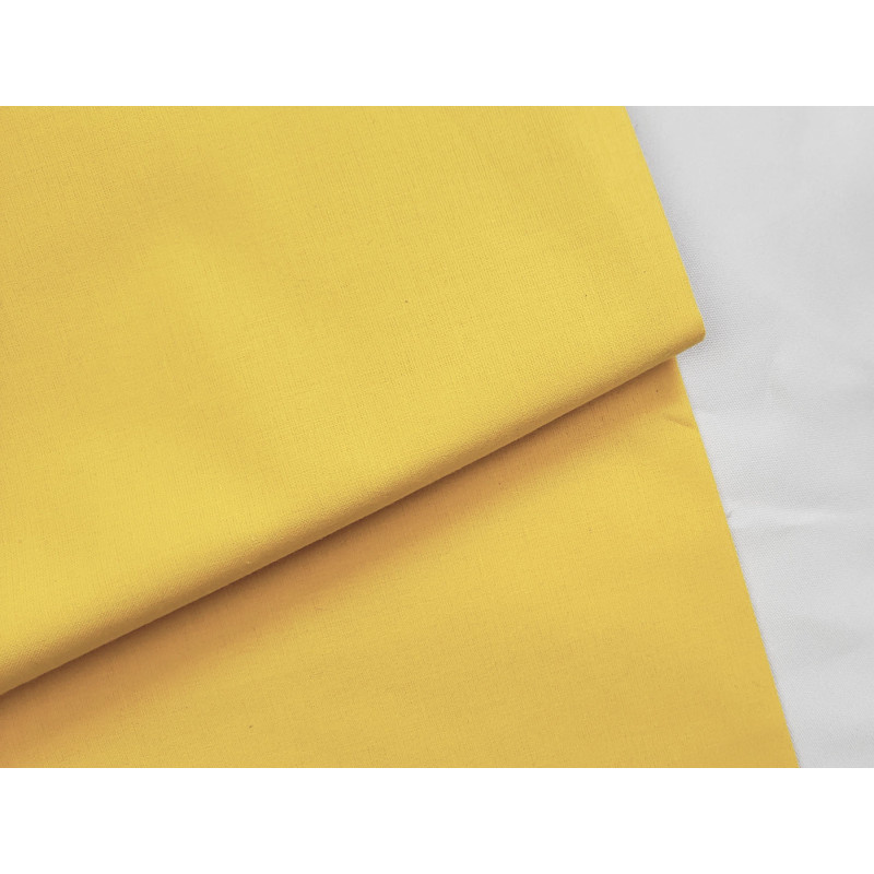 medium-weight cotton fabric - yellow- the fabric with the fold, placed across the frame