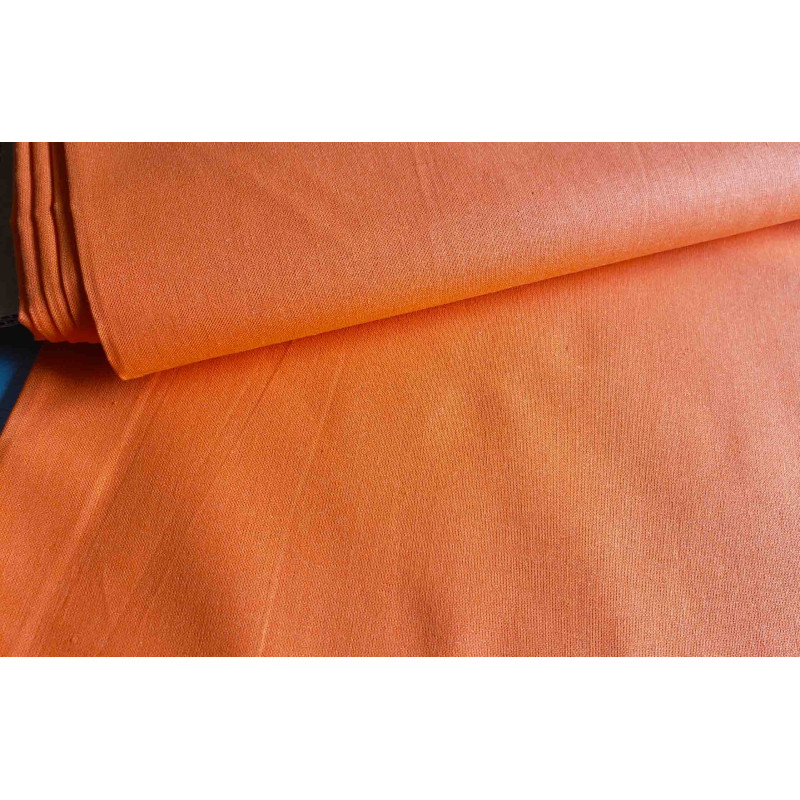 medium-weight cotton fabric - tangerine orange - the fabric with the fold, placed across the frame