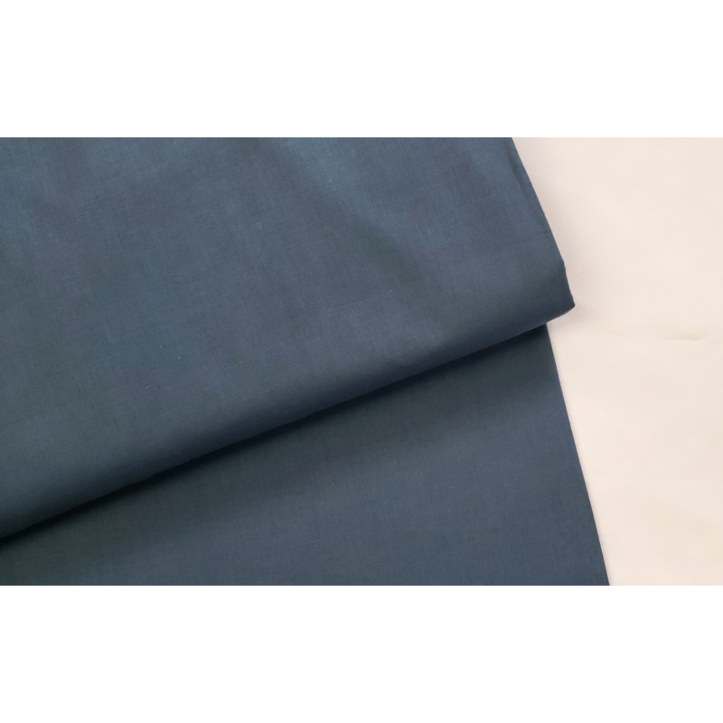 medium-weight cotton fabric -  dark petrol blue color, the fabric with the fold, placed across the frame