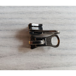 zip slider - metal gun - round puller - waterproof zip 5 on a grey background