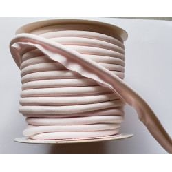 A full reel of plain, pale pink flanged piping cord on a white background