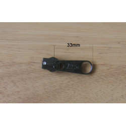 Black zip slider for coil zip in size 8, placed on wooden table with measurements