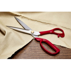 Dressmaking scissors - 9in or 23cm, placed on a wooden table with a piece of the fabric