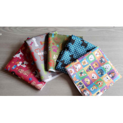 Water-resistant canvas fabric remnants bundle -dog theme fabrics, the bundle placed on a grey background