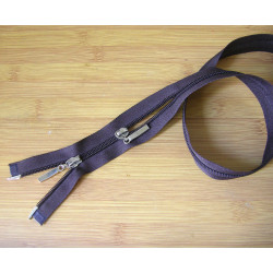 double slider plasic  zip - brown -100cm long, placed on a wooden background across the frame