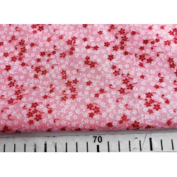 Ditsy Daisy Cotton Poplin - old rose background, the fabric with the ruler, to show the size of the design