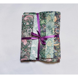 William Morriss designs -  Fat 8th bundle on a white background. The bundle is tied with a purple ribbon