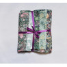 William Morriss designs -  Fat 8th bundle on a white background. The bundle is tied with a purple ribbon