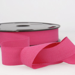 Full reel of white cotton twill tape on a white background