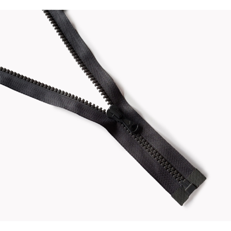 Dark grey, chunky zip - open end 50cm long, placed on a white background, across the frame Dark grey, chunky zip - open end 50cm long, placed on a white background, across the frame