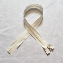 invisible zip size 5 - off white - 55cm from YKK brand. The zip is placed on a white background