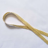 Upholstery braid 14mm - Cream color, a loop shape placed on a white background