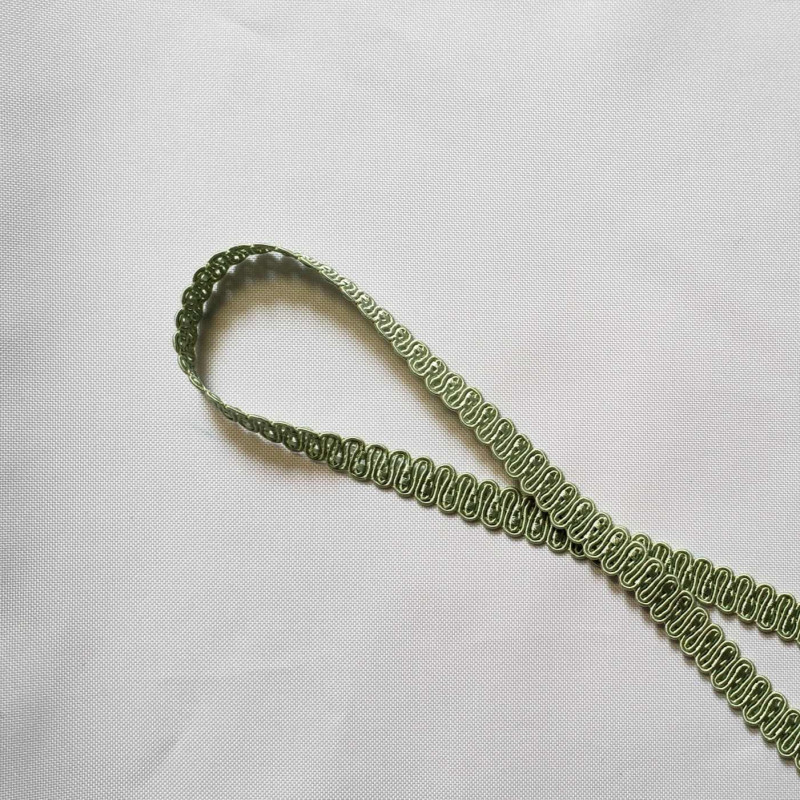 Upholstery braid 14mm - light Green color, a loop shape placed on a white background