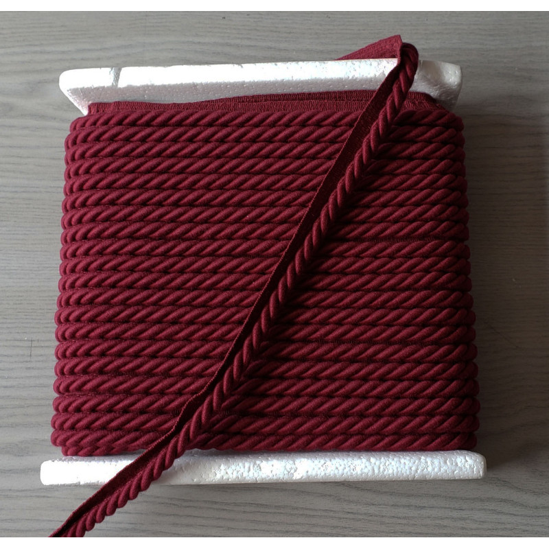 Upholstery piping cord 10mm - burgundy color, full reel, on grey background