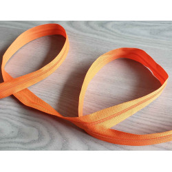 Plastic, nylon, Continuous zip - Orange size 3, twisted on wooden table