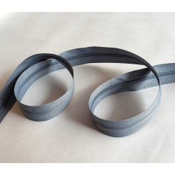 Plastic, nylon, Continuous zip - Dark grey size 3, twisted on wooden table