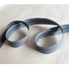 Plastic, nylon, Continuous zip - Dark grey size 3, twisted on wooden table