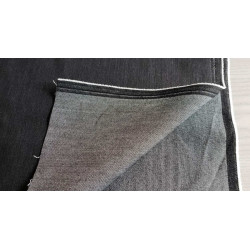 stretch denim fabric  - black color, placed on the table with the fold