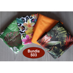 Water-resistant canvas fabric remnants bundle - tropical mix theme. The bundle is placed on a wooden background