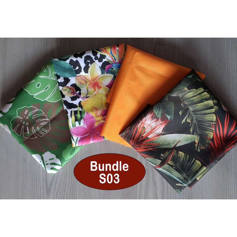 Water-resistant canvas fabric remnants bundle - tropical mix theme. The bundle is placed on a wooden background