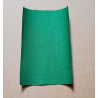 Iron-on  repair fabric in an intense green color. the sheet placed on a beige background