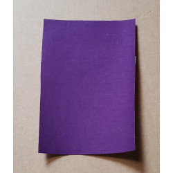 Iron-on repair fabric patch in a  purple color, placed on a beige background